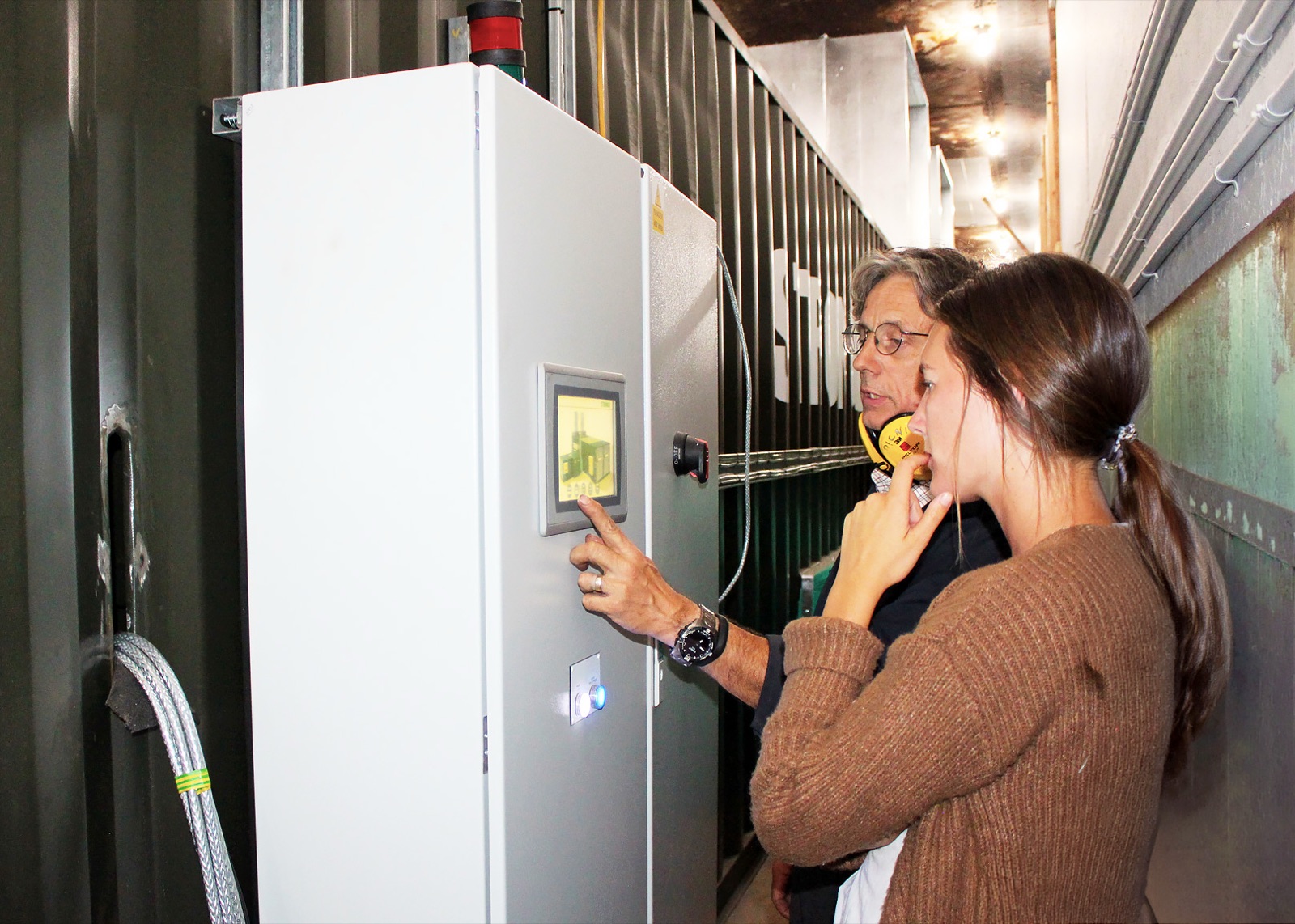 Operators using the FlowDrya DryStation control panel during a hemp drying run