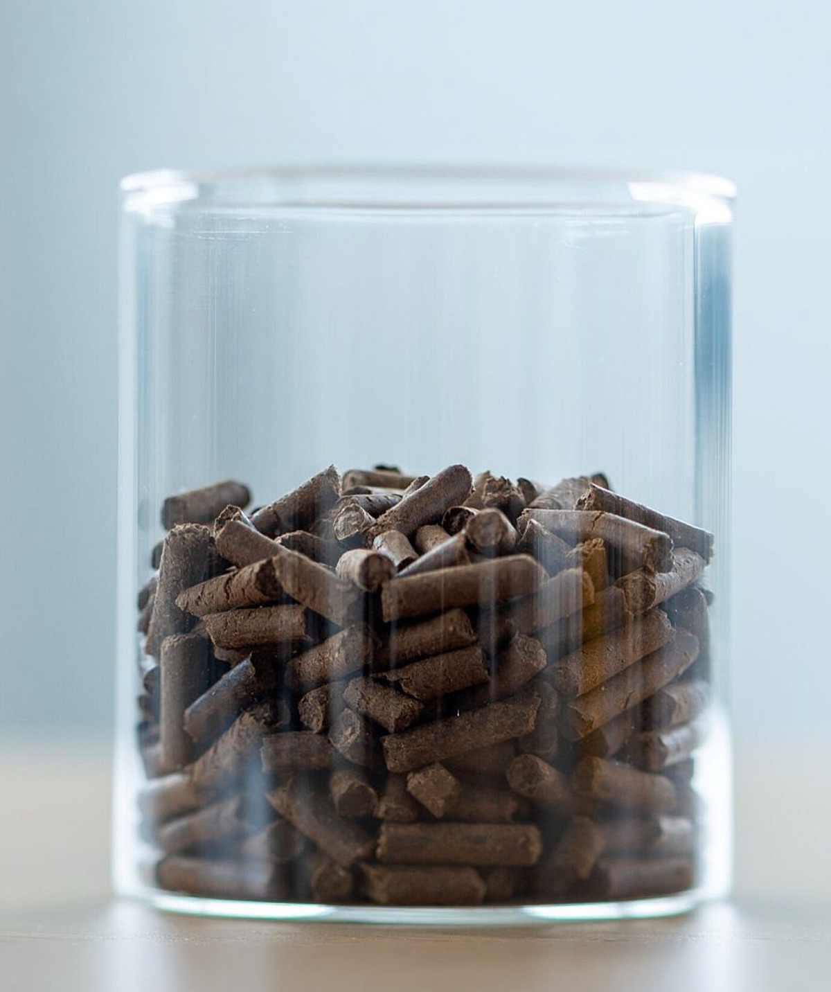 Glass jar filled with dried BSF frass fertiliser pellets produced after FlowDrya drying