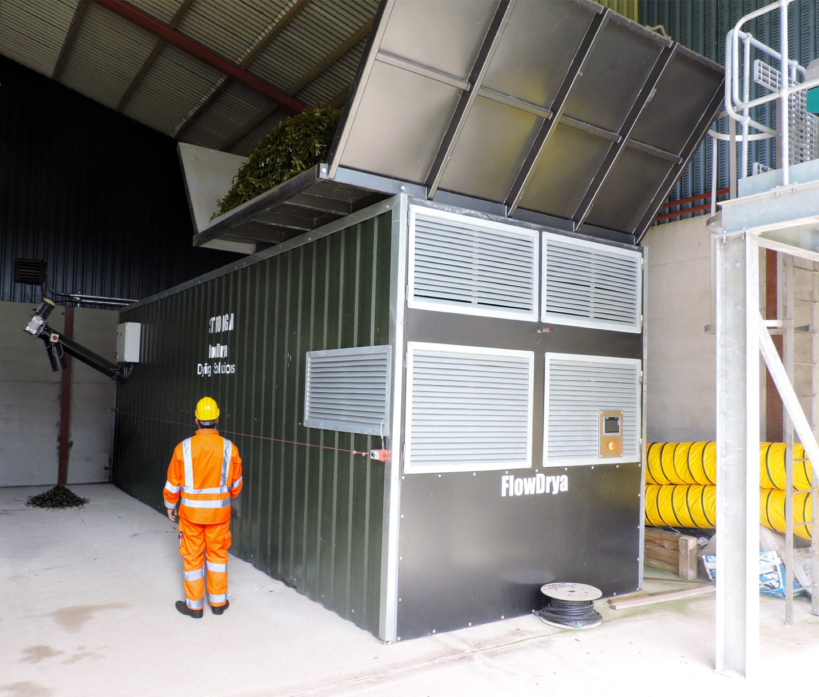STRONGA FlowDrya seaweed drying installation with operator in hi-vis inspecting the unit